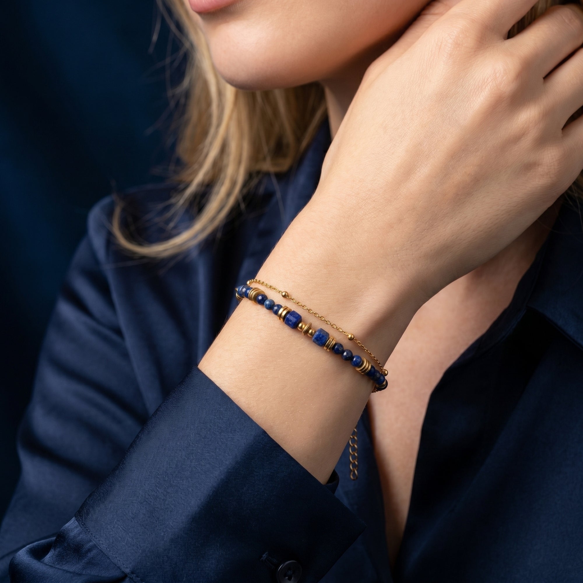 Woman wearing the Azure Drift lapis lazuli bracelet in 18K gold plated stainless steel on her wrist.