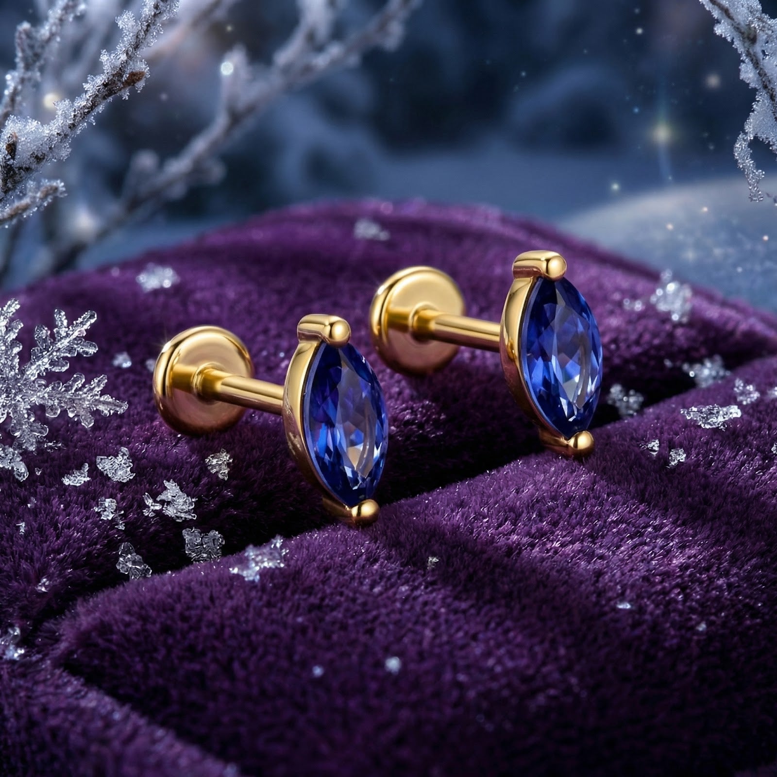 Marquise simulated tanzanite flat back stud earrings in 18K gold vermeil on purple velvet with snowflakes.