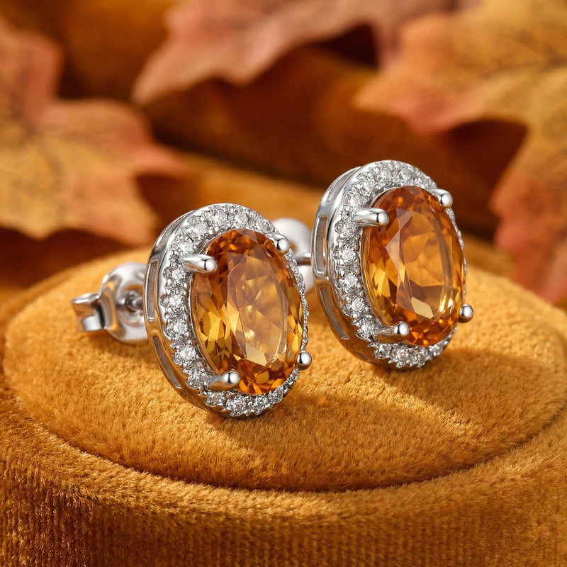 Macro shot of oval simulated topaz halo stud earrings in S925 sterling silver showing the side setting and earring post.