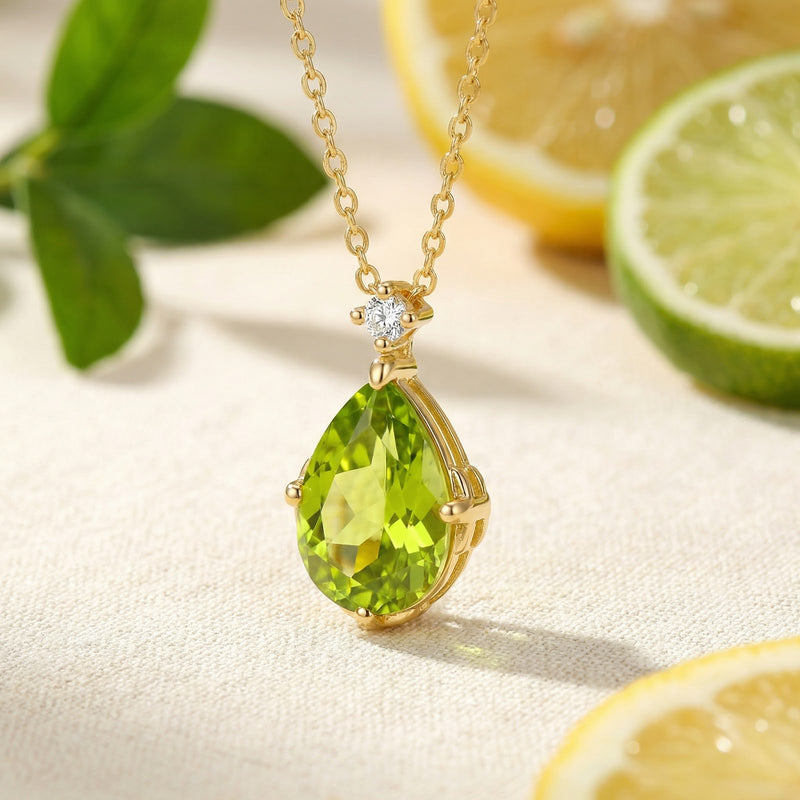Close-up of the pear-shaped simulated peridot pendant in 18K gold vermeil, highlighting the vibrant green stone.