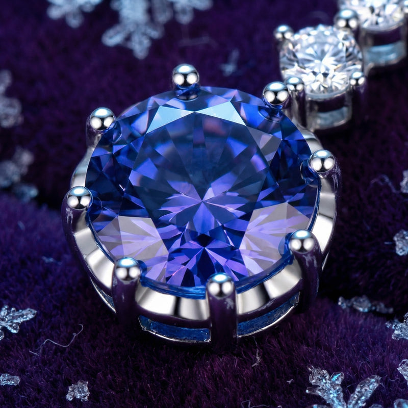 Macro view of a round cut simulated tanzanite stone in a sterling silver prong setting.