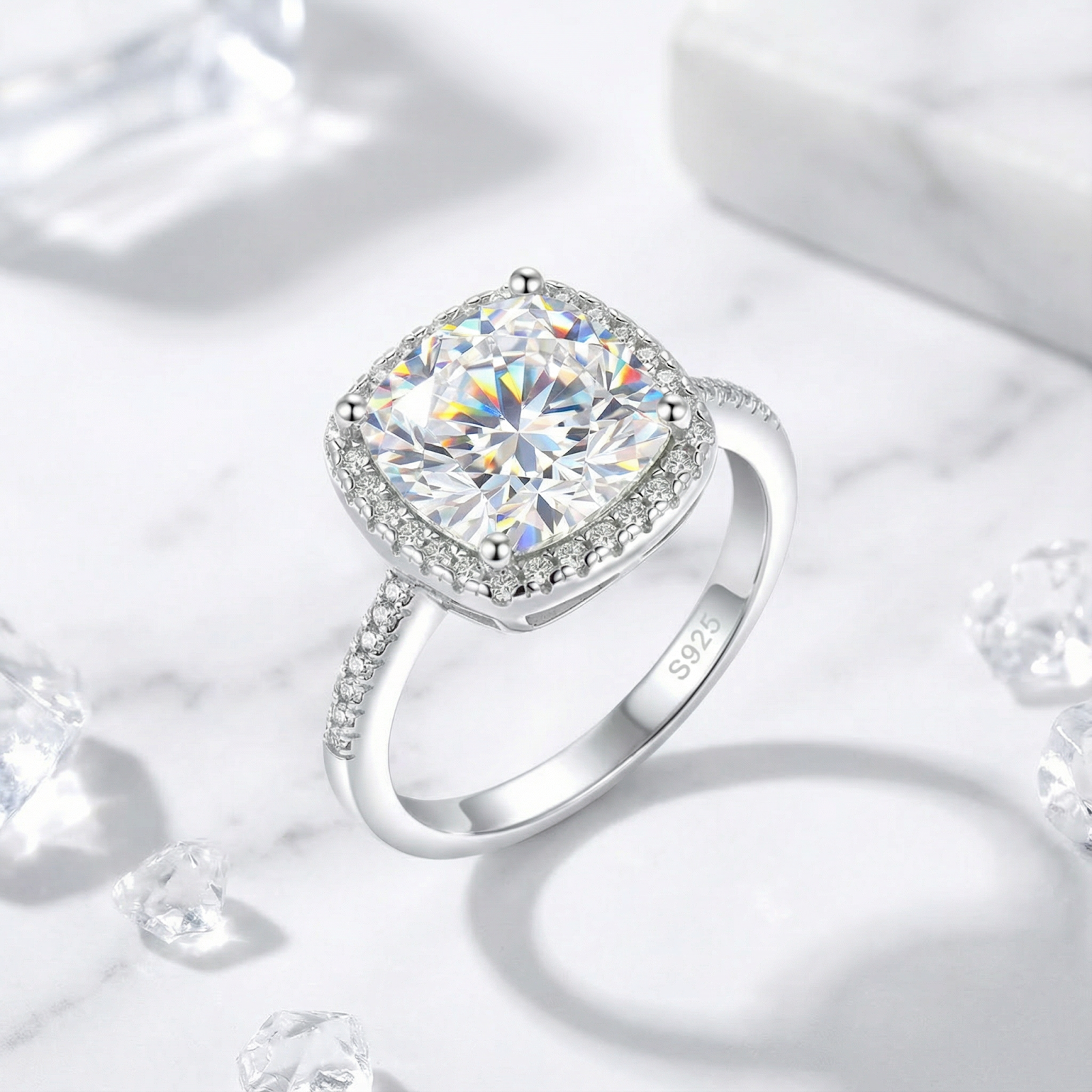 Cushion cut simulated diamond halo ring in sterling silver with S925 stamp on a marble surface.