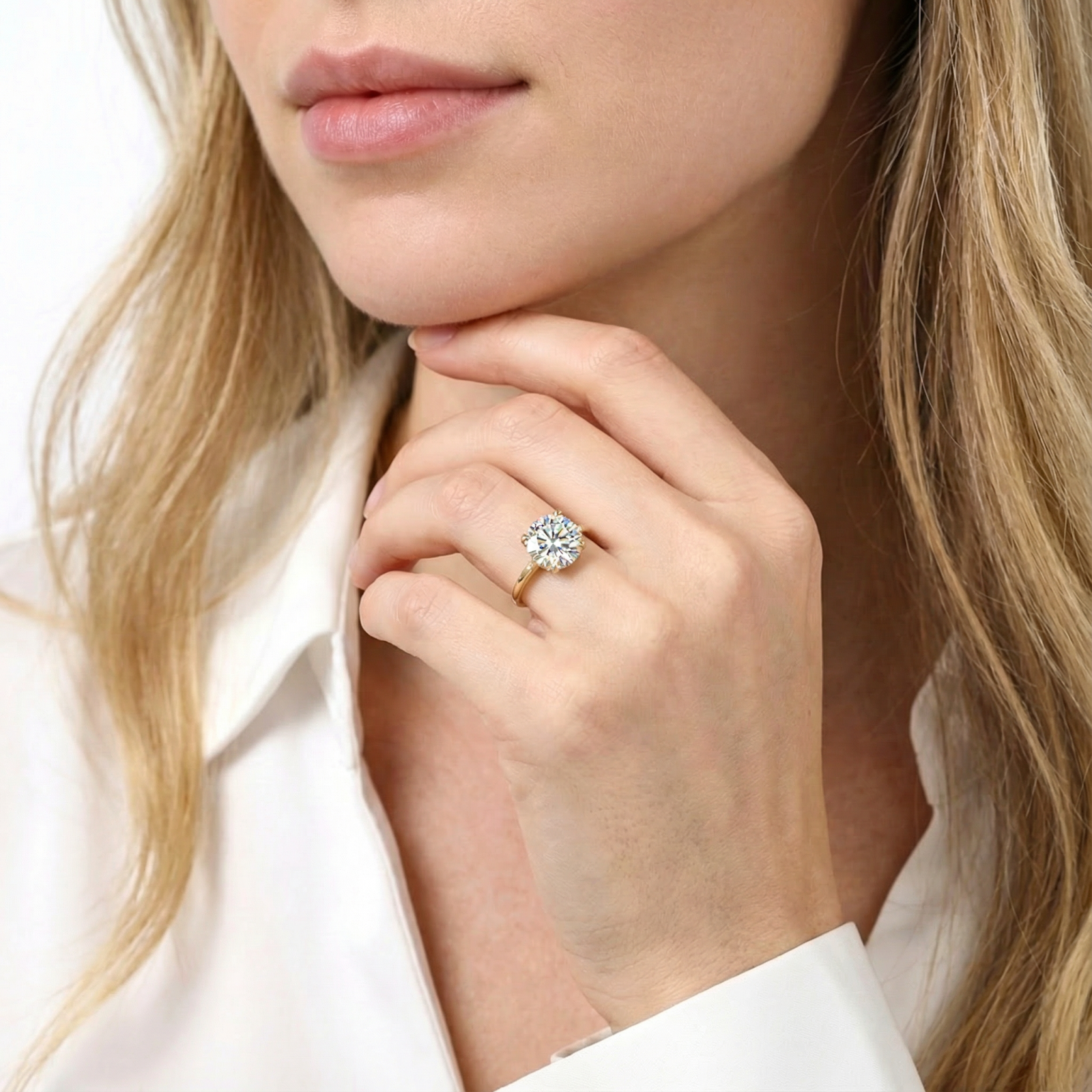 Model wearing the Mirellia solitaire ring in 18K gold vermeil with a cushion cut simulated diamond.