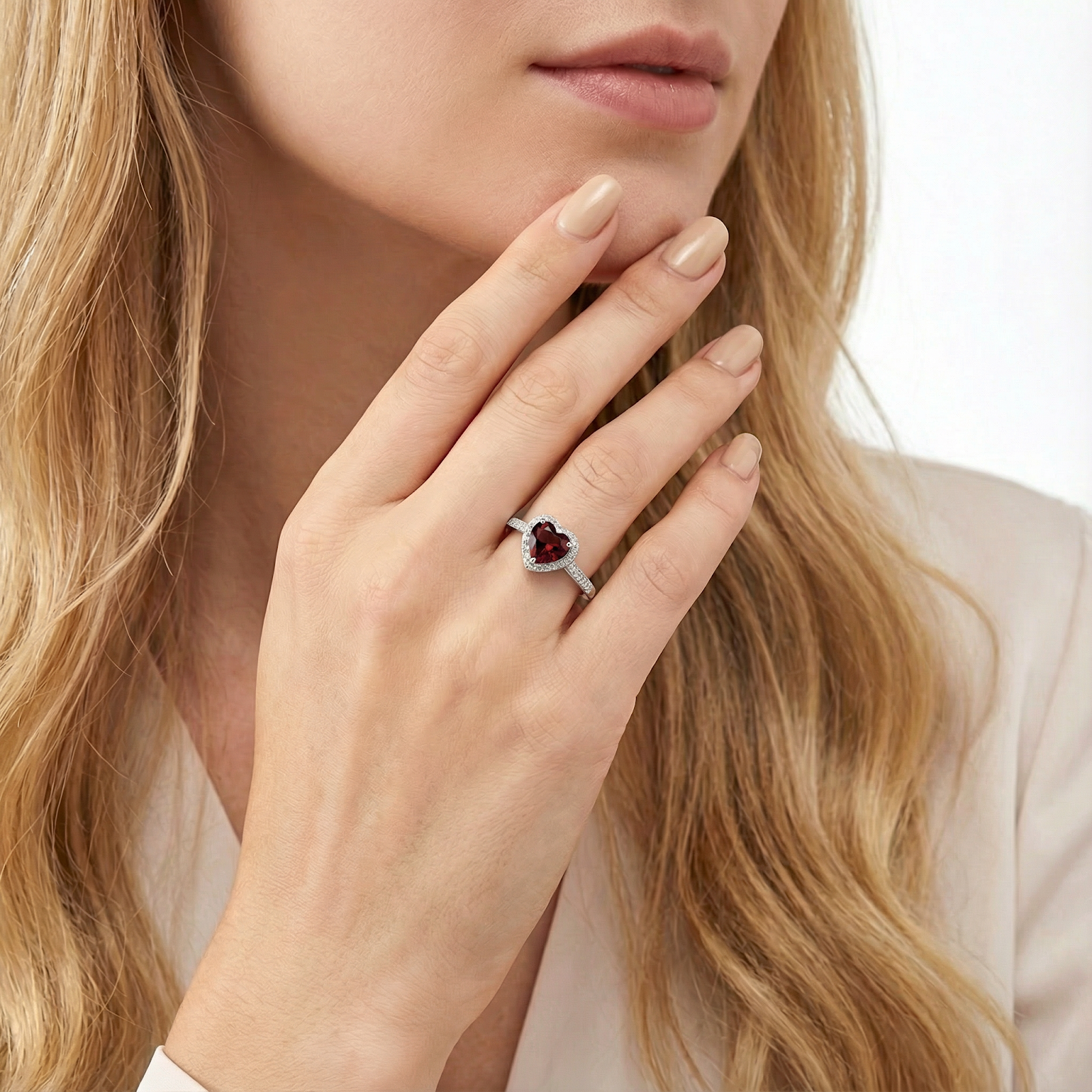 Woman wearing the heart-cut simulated garnet S925 sterling silver ring on her hand.
