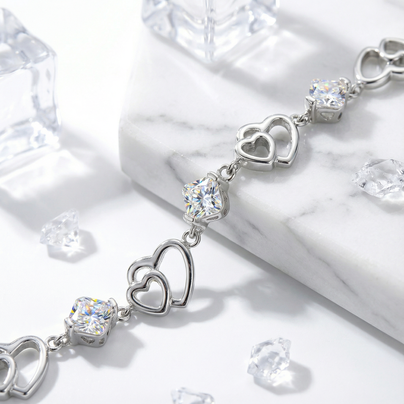 Close-up of S925 sterling silver heart links and round-cut simulated diamonds on the Elaraea heart bracelet.