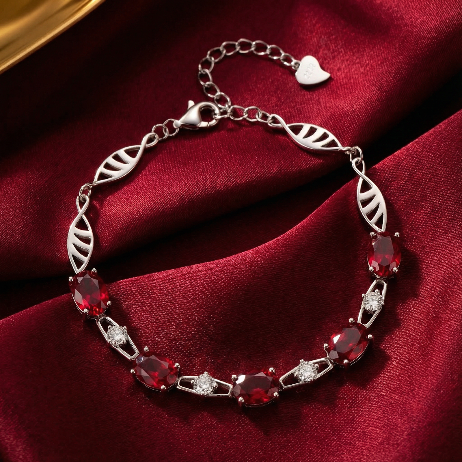 Sterling silver station bracelet with oval-cut simulated rubies on a red satin background.