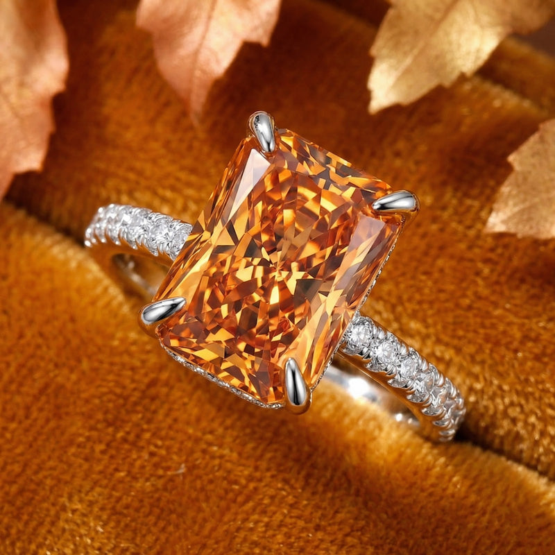 Macro view of a radiant cut simulated topaz and pavé setting on a rhodium-finished sterling silver ring.