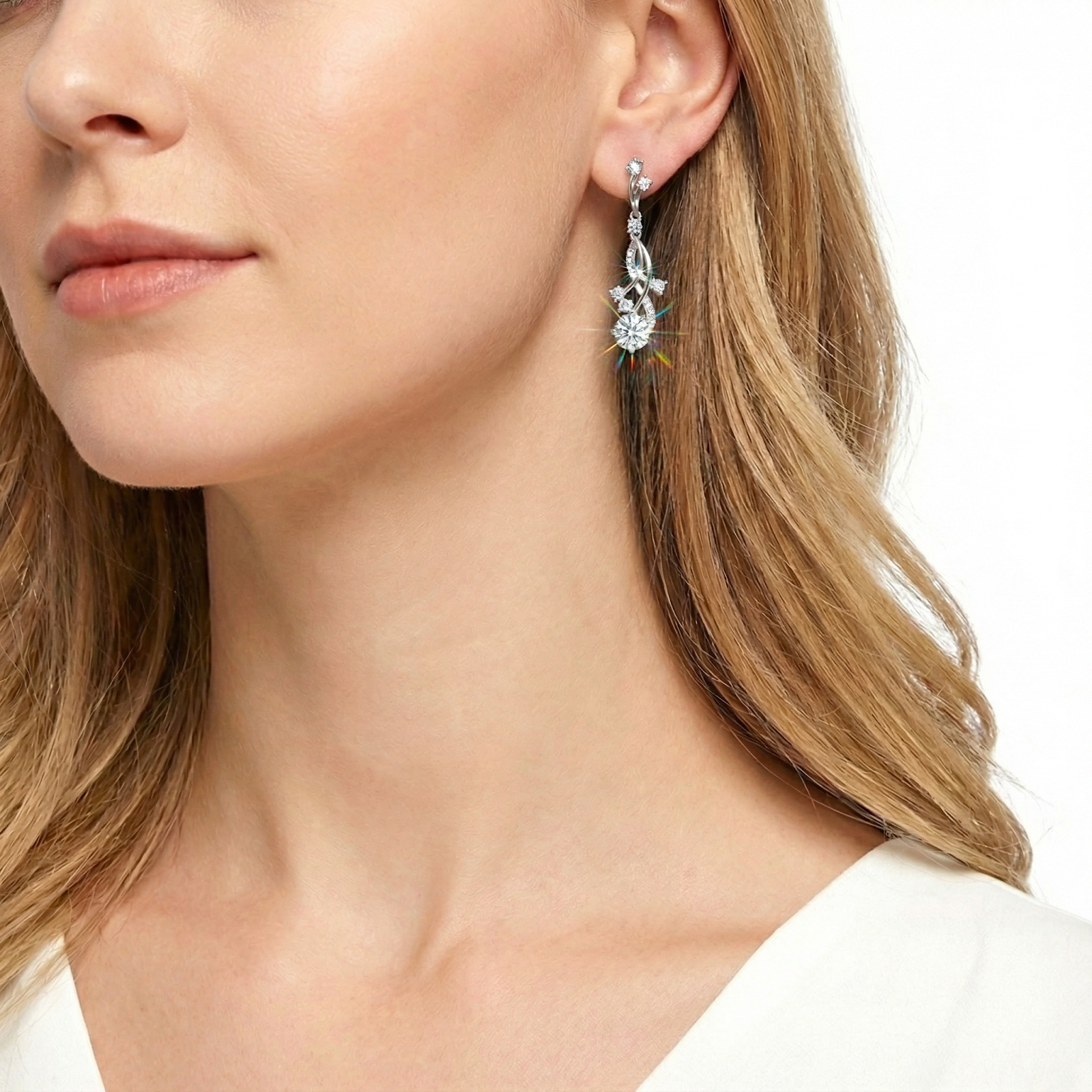 Woman wearing a silver vine drop earring with sparkling round zirconia stones, showcasing the elegant dangle length.