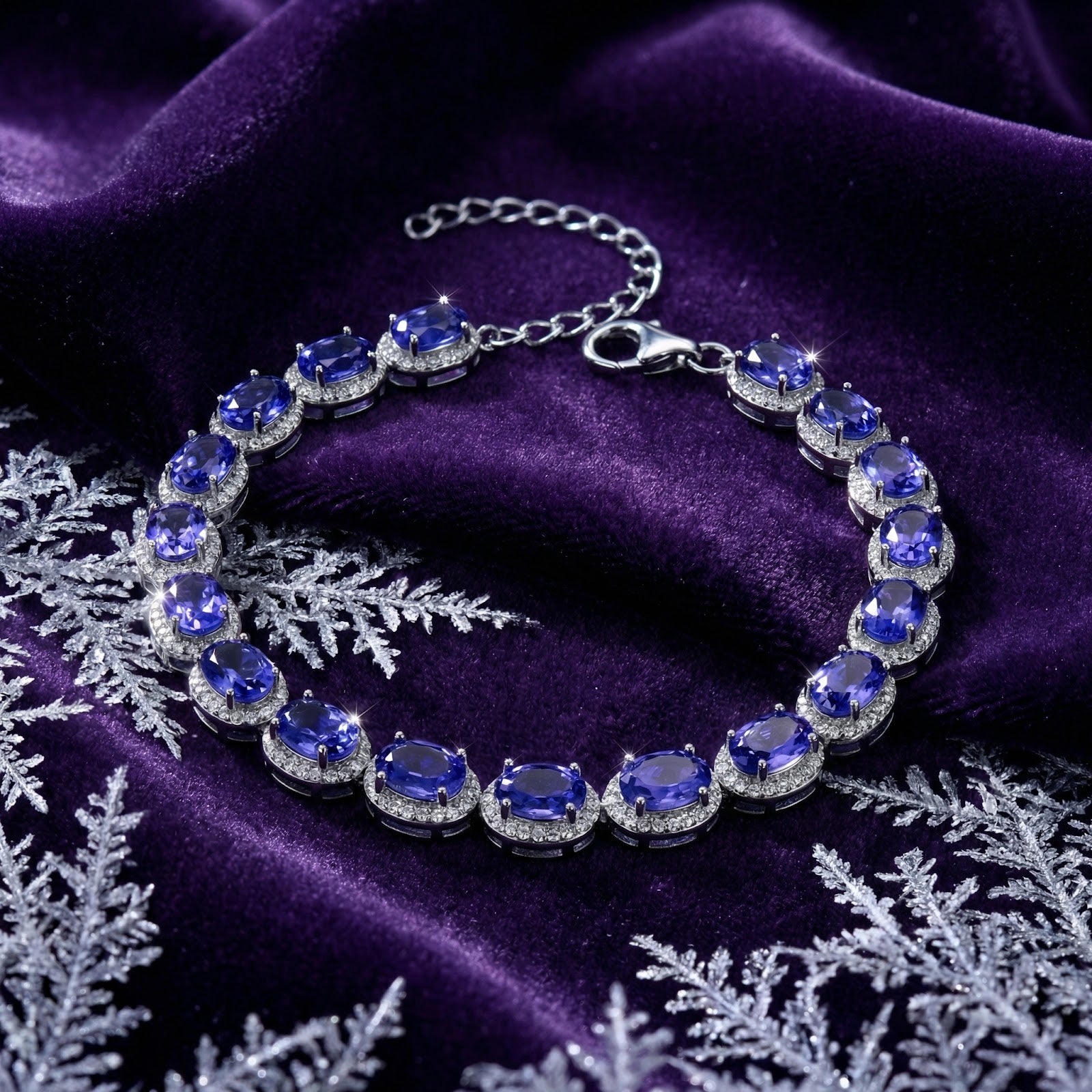 Sterling silver tennis bracelet with oval simulated tanzanite stones on purple velvet with snowflakes.