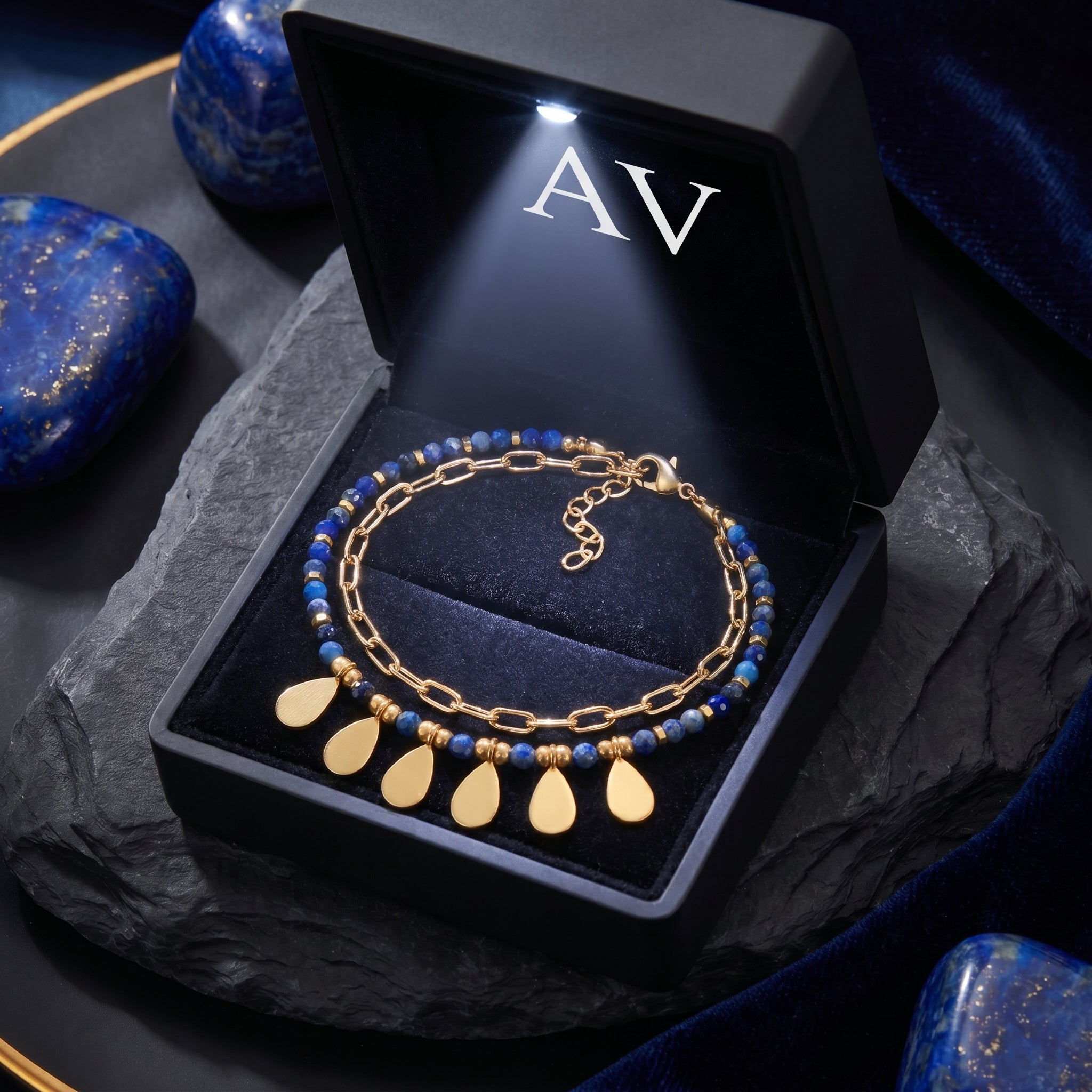 Sylvan Leaf double-layered gold plated lapis bracelet in an illuminated gift box with AV logo.