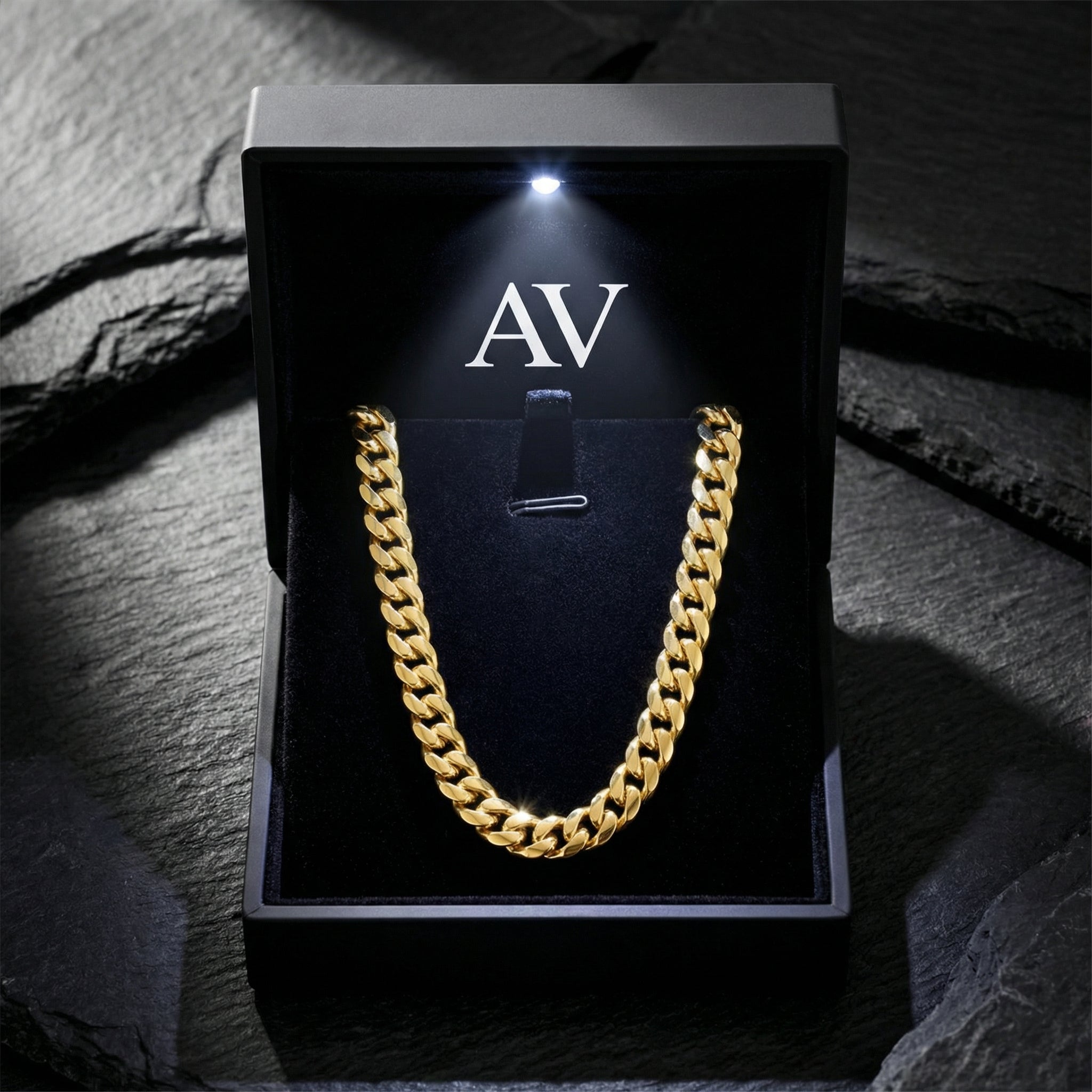 6mm gold Cuban chain displayed inside a premium black lighted jewelry box with AV branding.