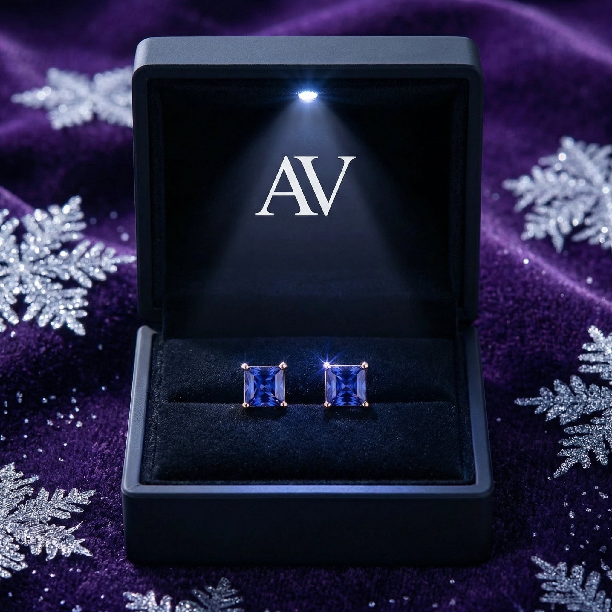 Princess-cut simulated tanzanite earrings in 18K rose gold vermeil inside a lighted black AV jewelry box.