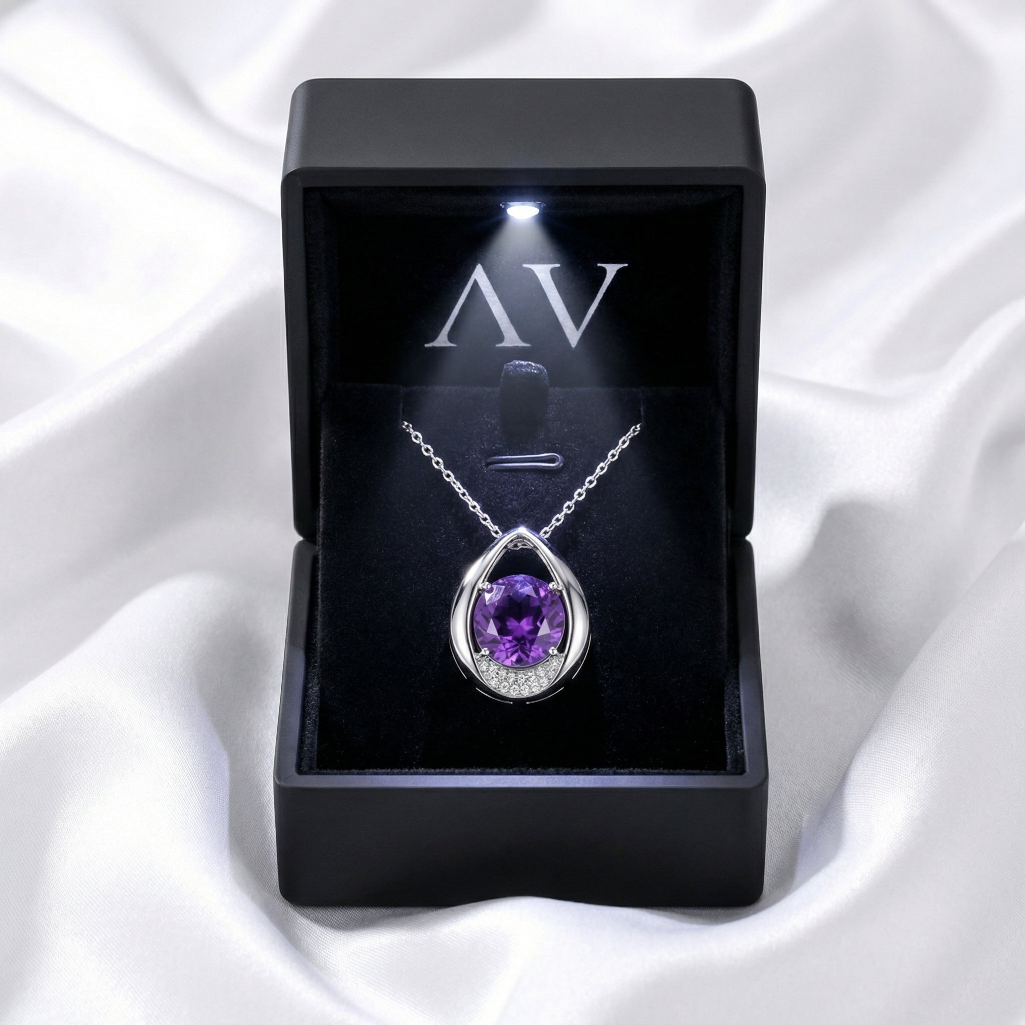 The Isolde drop necklace with a purple simulated amethyst in a black premium LED-lit presentation box.