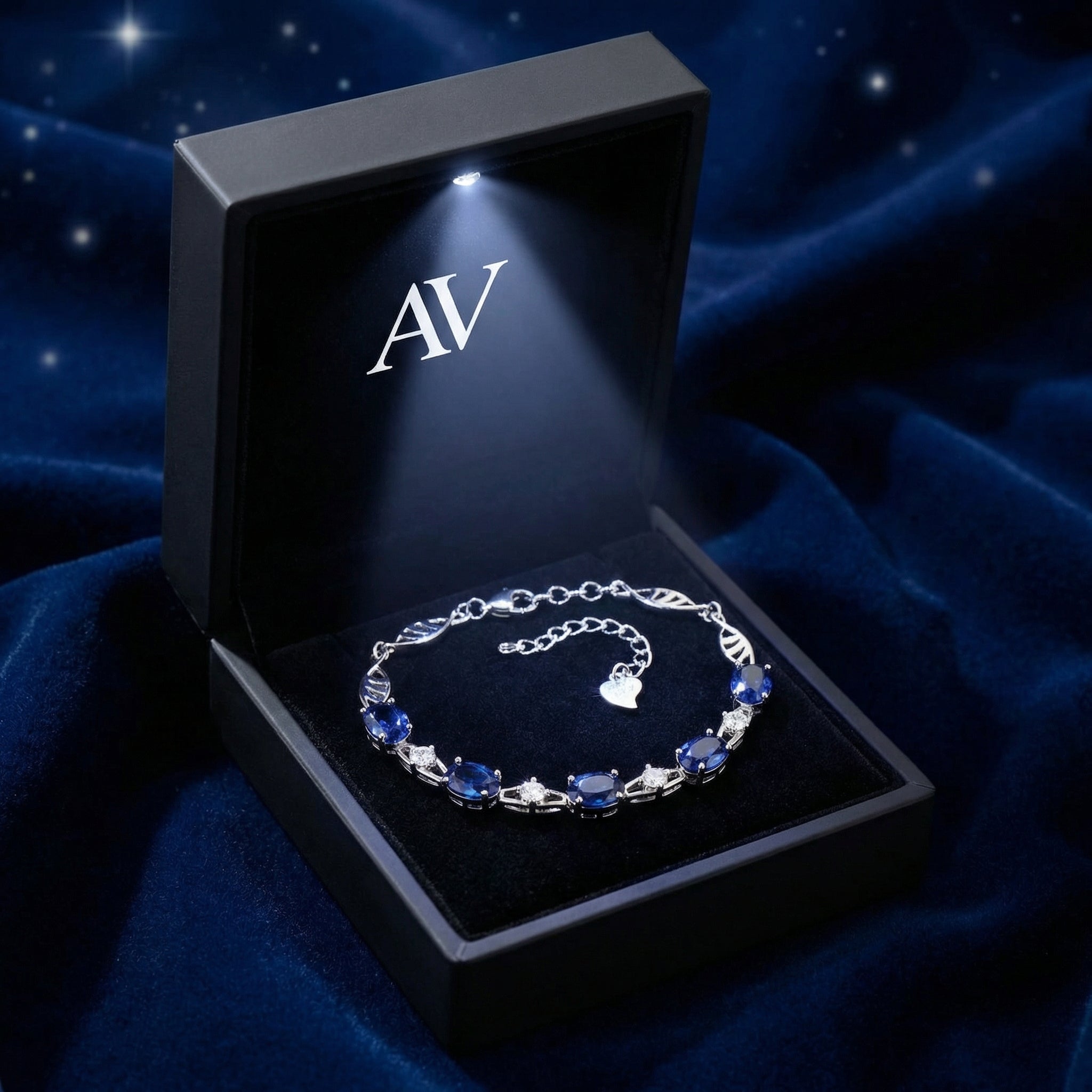 Sterling silver simulated blue sapphire bracelet inside a black lighted jewelry presentation box.