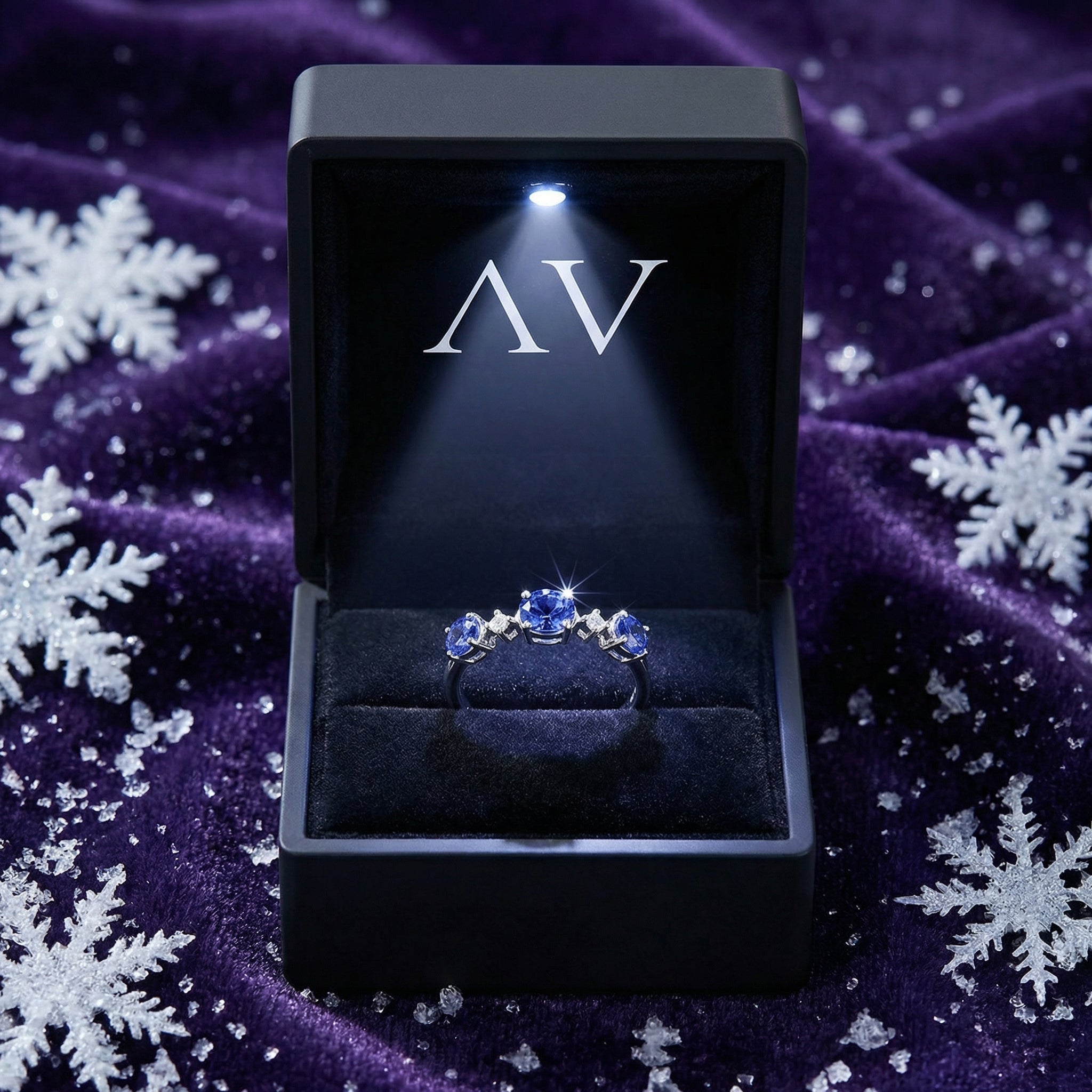 Marissara Trinity Ring in S925 sterling silver with blue simulated tanzanite in a lighted black jewelry gift box.
