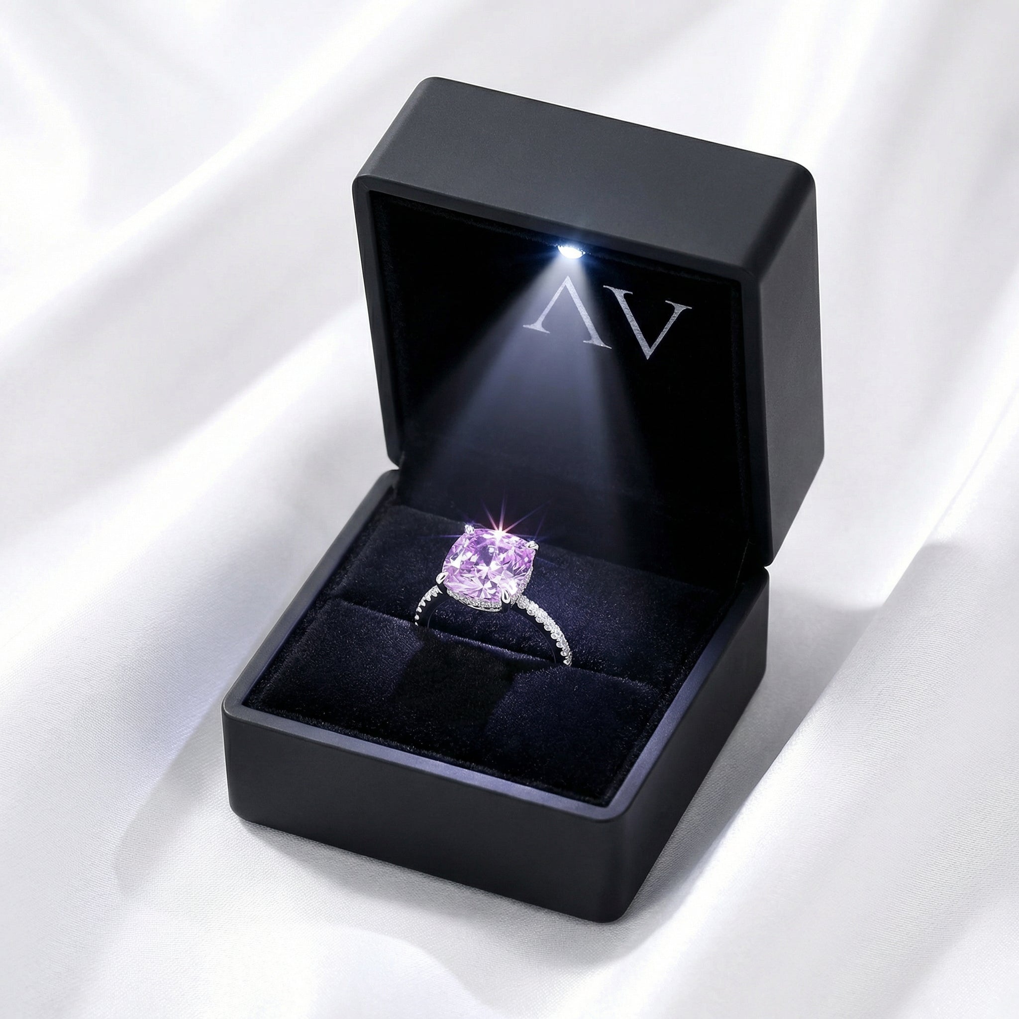 Cushion cut simulated amethyst sterling silver ring inside a black LED-lit presentation gift box.