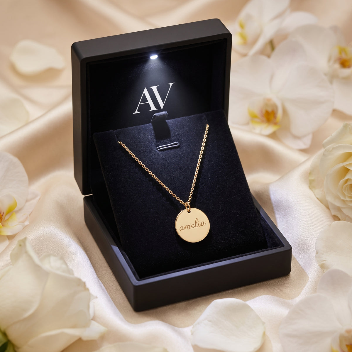 Gold Eloise necklace inside a premium black LED-lit gift box with floral decor.