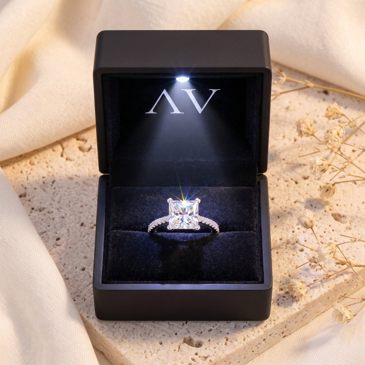 A solid gold ring with a natural zircon center stone presented in an LED gift box.