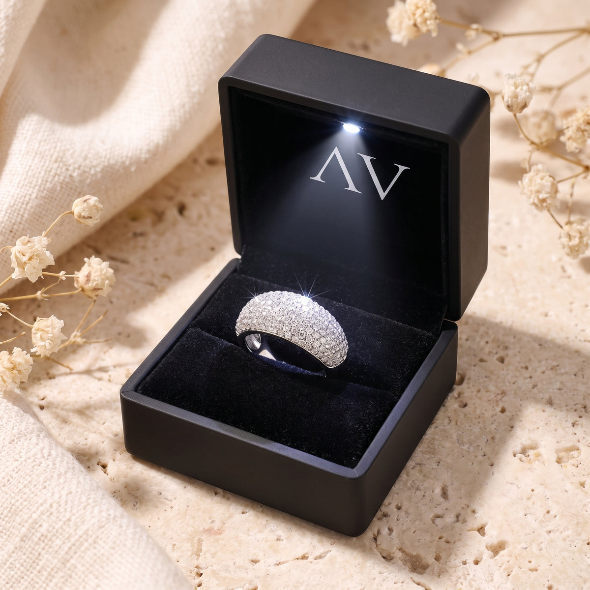 Solid white gold pave dome ring in a black LED-lit gift box with brand logo.