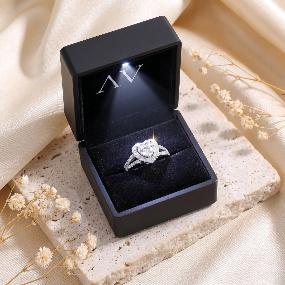 Heart-cut cubic zirconia promise ring displayed in a black LED-lit gift box.