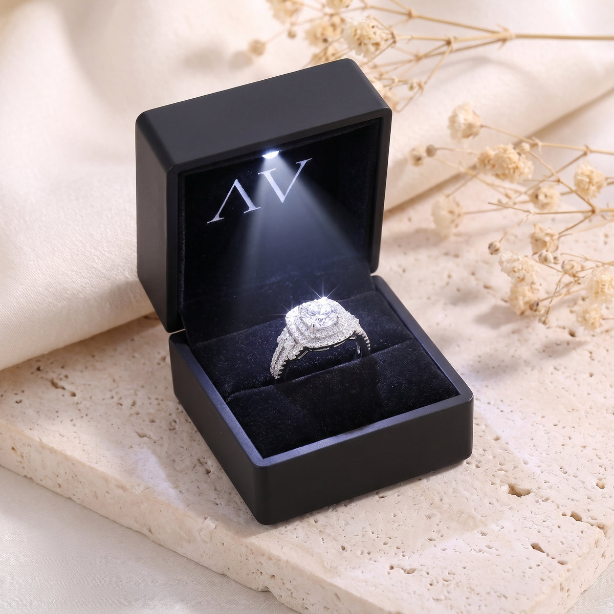 Sterling silver cushion double halo ring in a black LED-lit jewelry box.