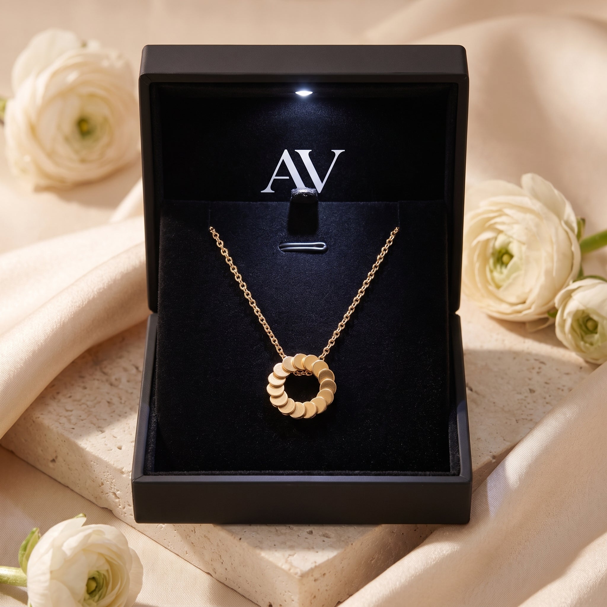 Freya 18K gold plated necklace displayed in a black illuminated jewelry gift box.