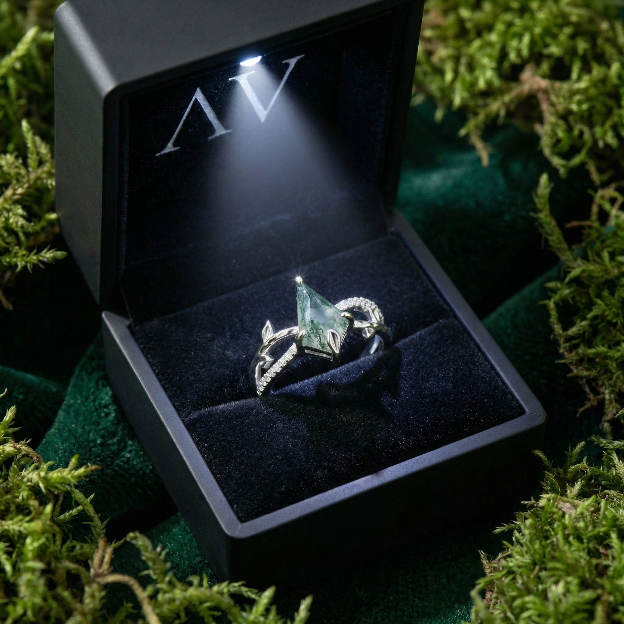 Kite cut moss agate sterling silver ring inside a premium lighted black jewelry gift box.