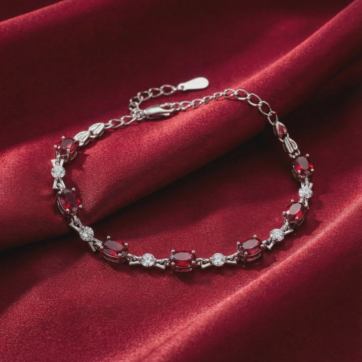 The Vivara Oval Simulated Ruby Tennis Bracelet in solid gold.