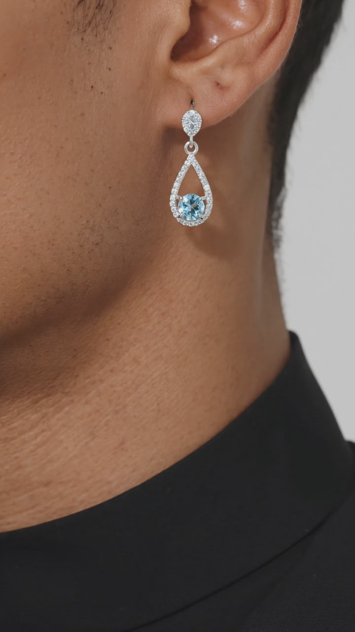 Video of solid gold teardrop drop earrings with simulated aquamarine.