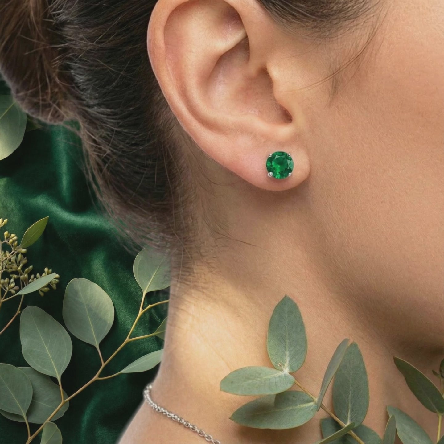 Simulated emerald stud earrings in solid gold.