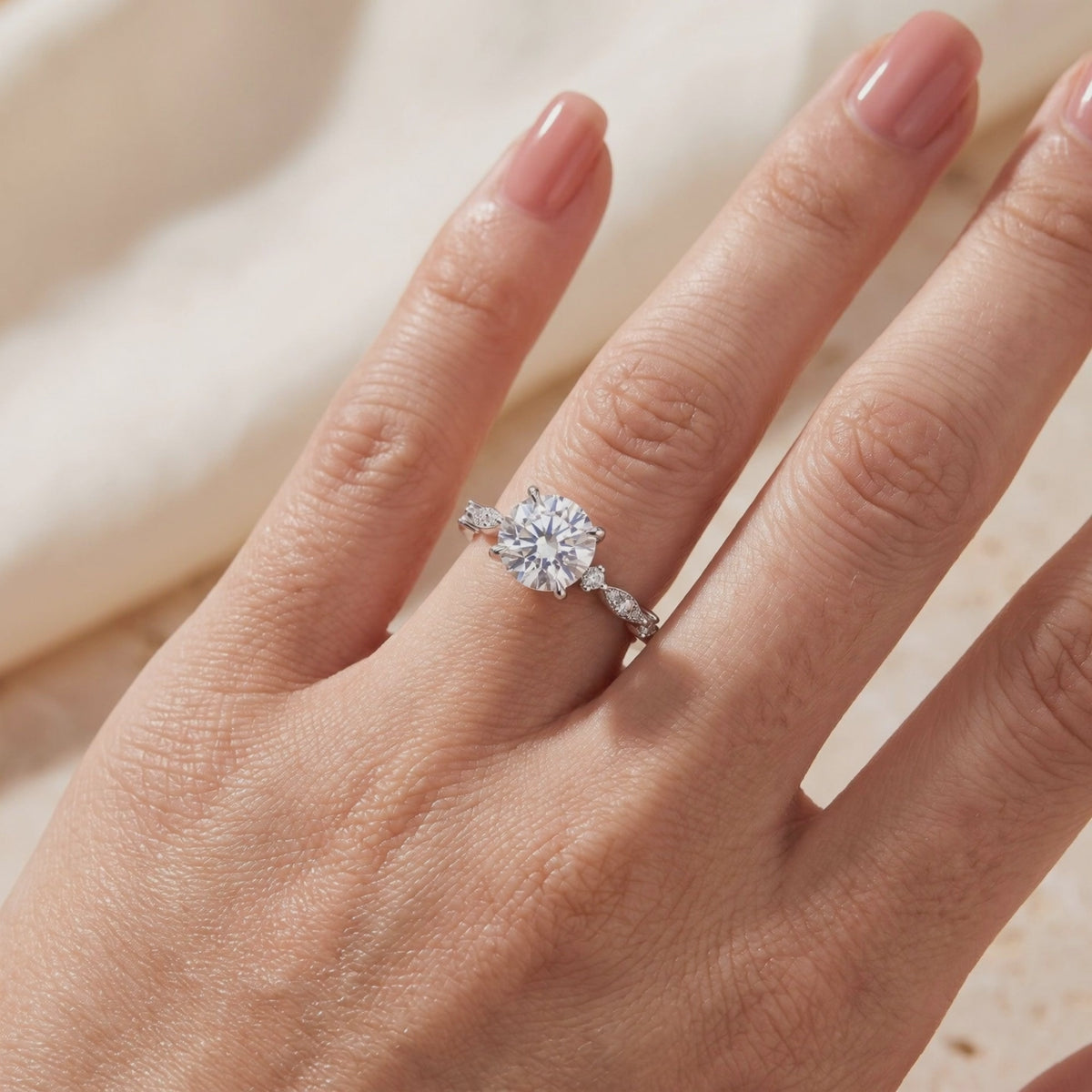 Round simulated diamond solitaire ring with a side-accented silver band, worn on a hand.