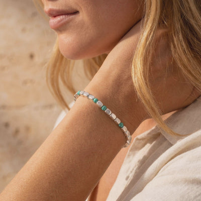 Model wearing the Alamosa turquoise and silver bead bracelet on her wrist.