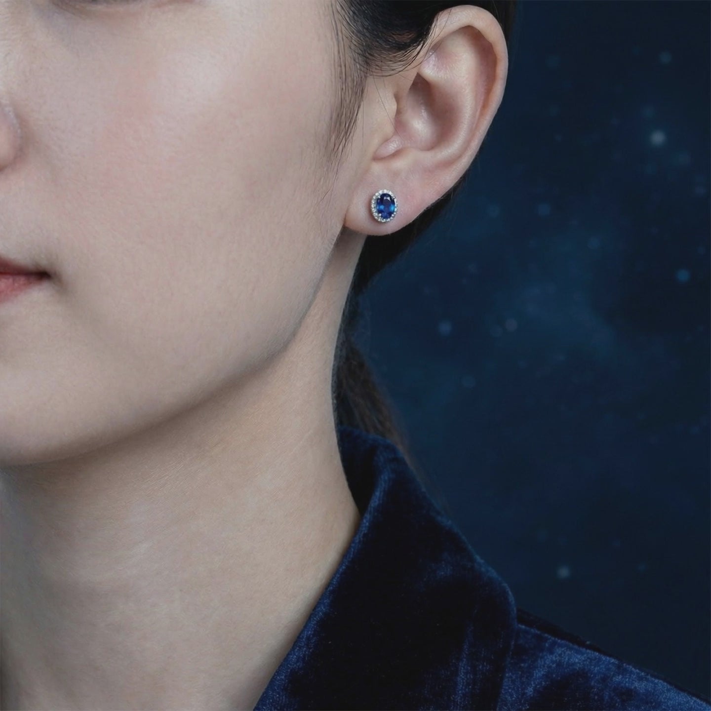 Simulated sapphire halo stud earrings in solid gold.