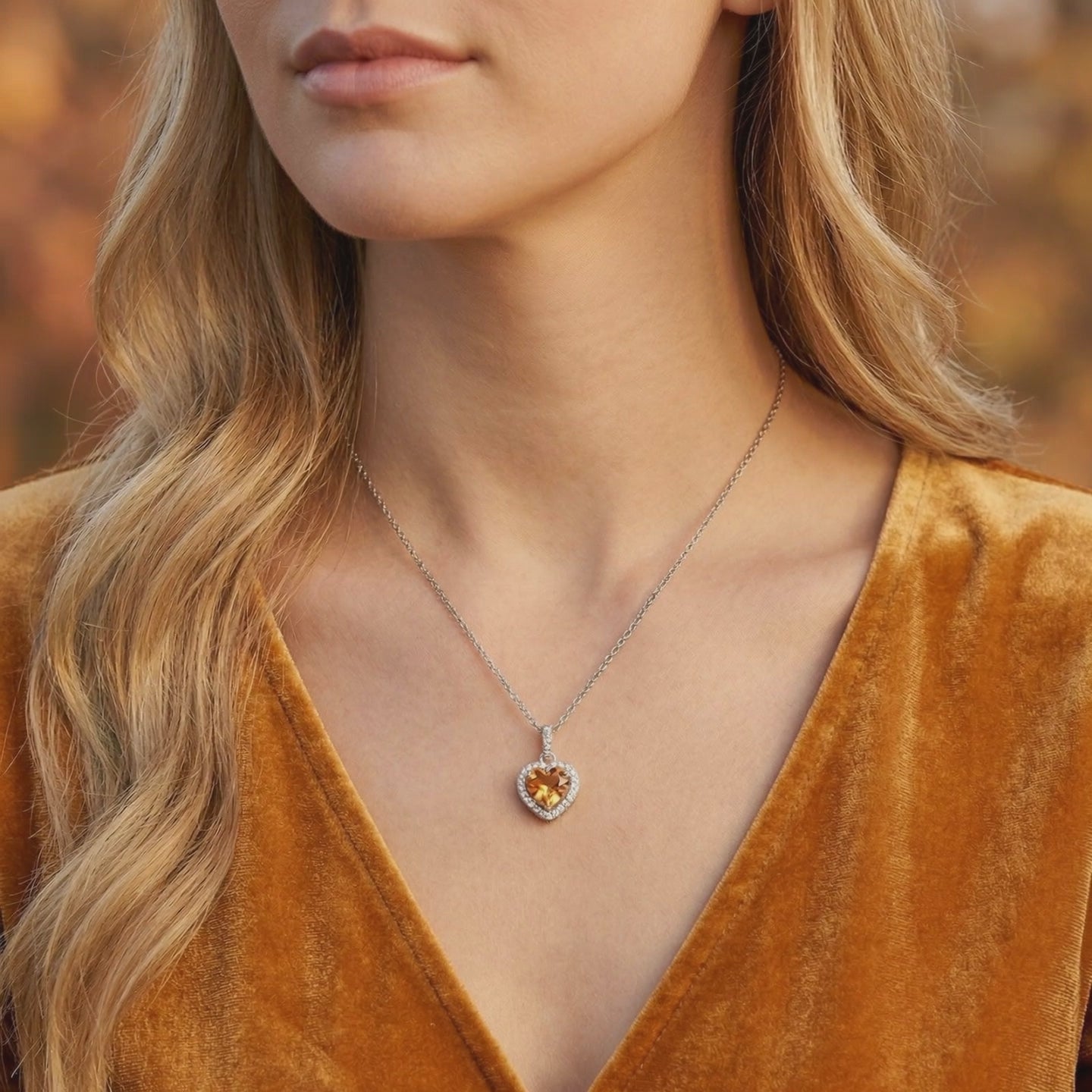 A solid gold necklace with a heart-cut simulated topaz pendant.