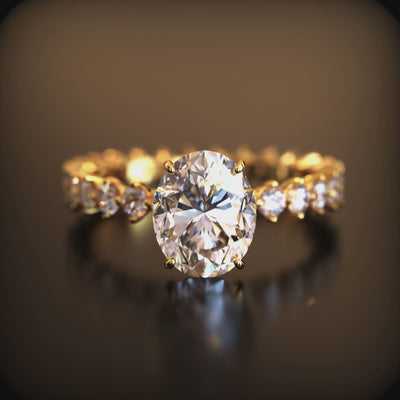 A ring with a 2 carat oval moissanite center stone and a gold eternity band.
