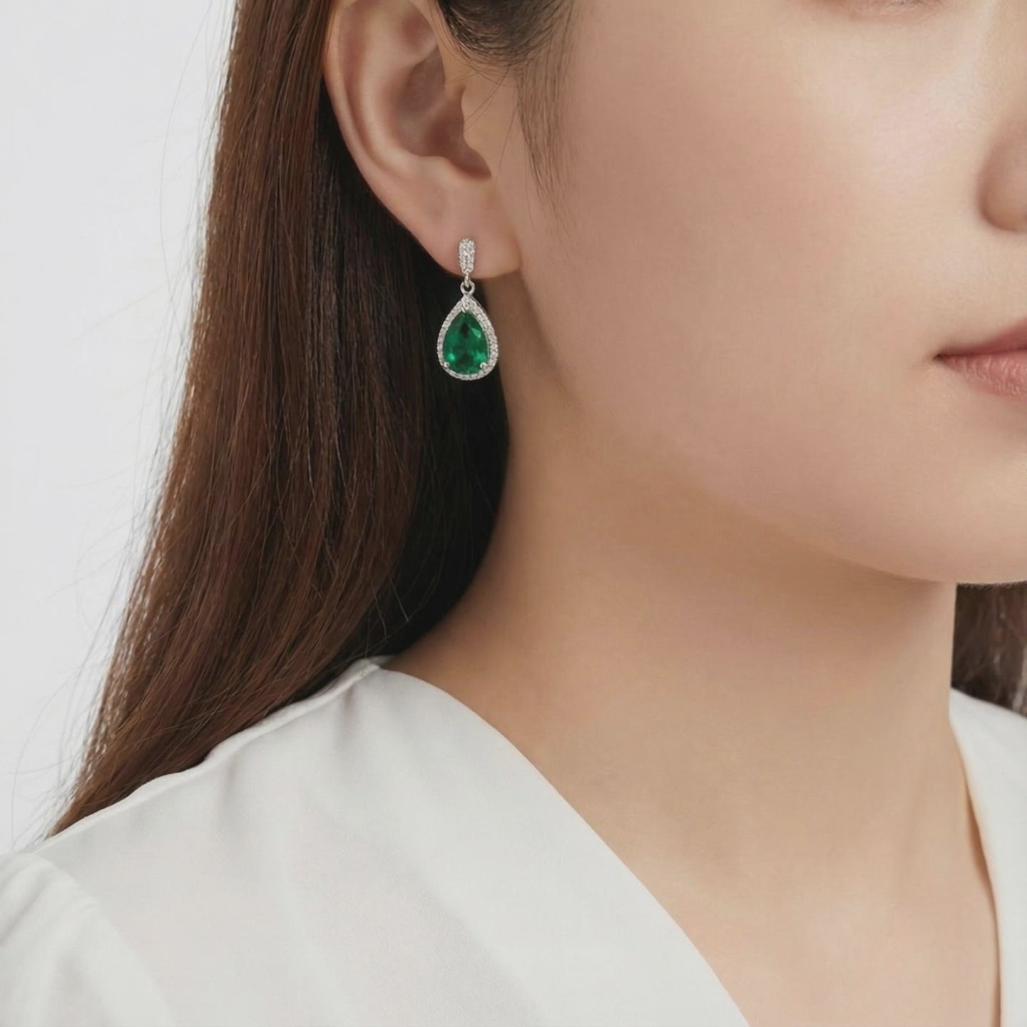 Simulated emerald drop earrings in solid gold.