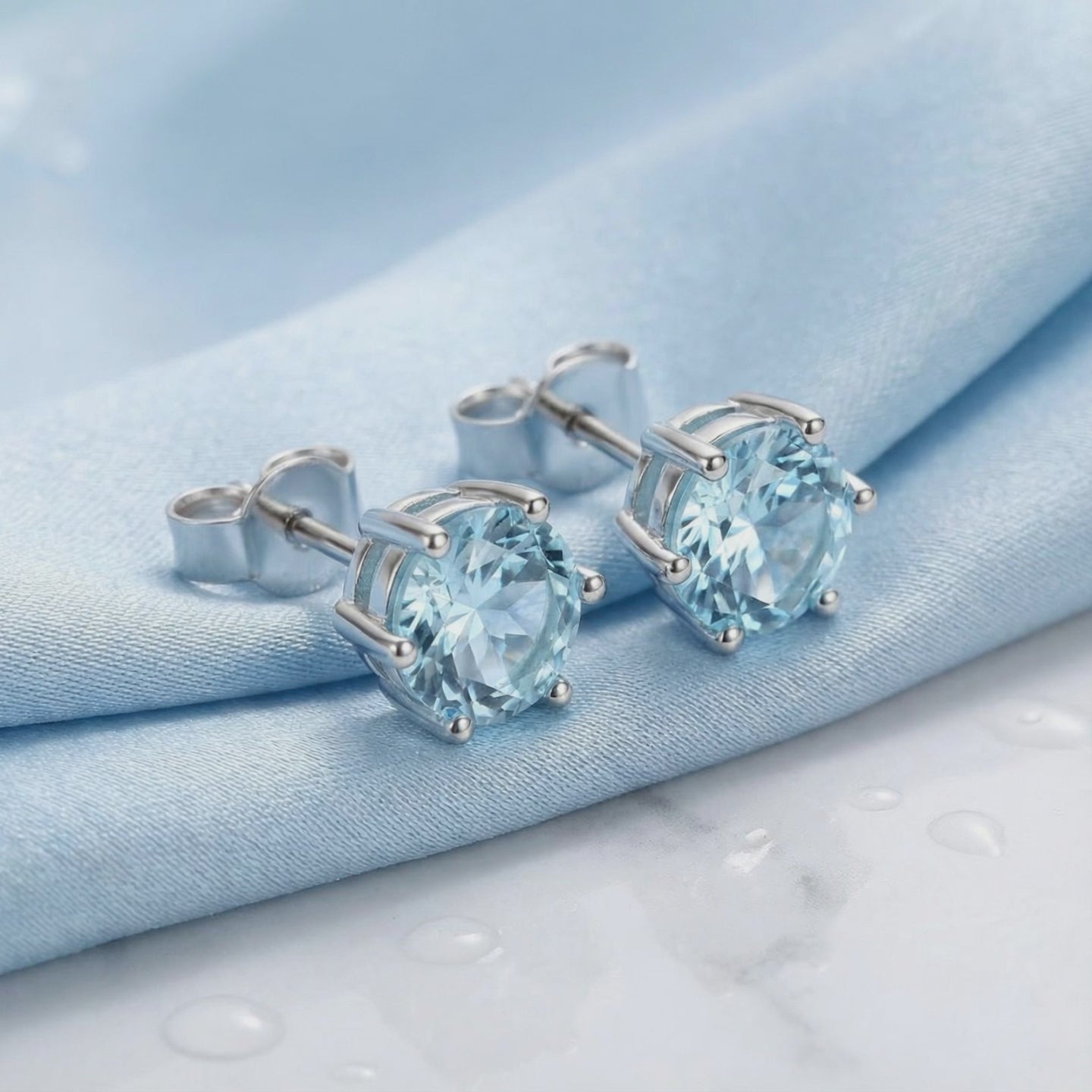 Simulated aquamarine stud earrings in solid gold.