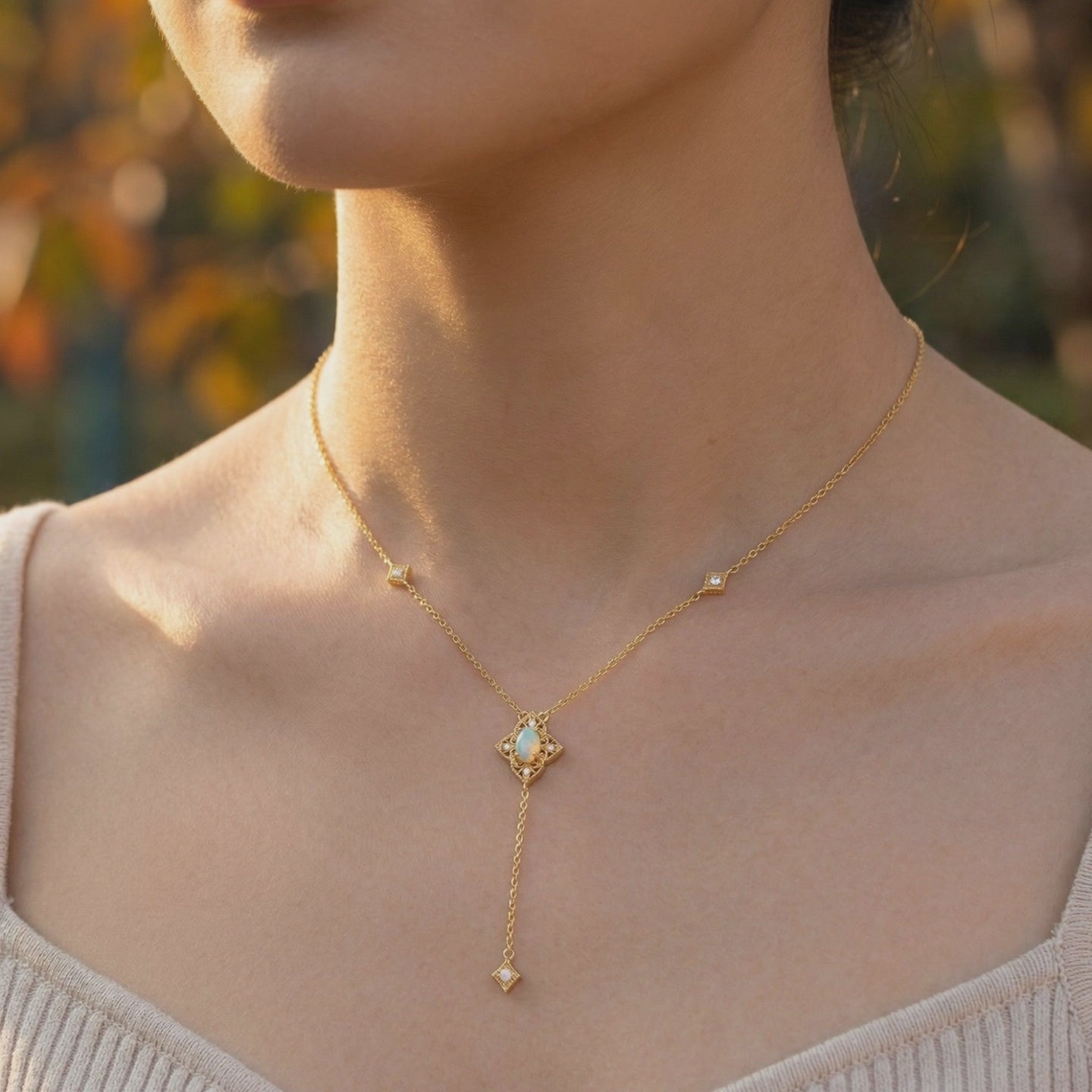 Solid gold necklace with an oval white opal pendant.