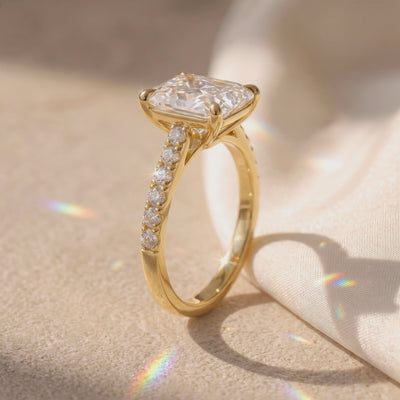 Video preview showing a side profile of the gold-toned radiant-cut solitaire ring with a pavé band.