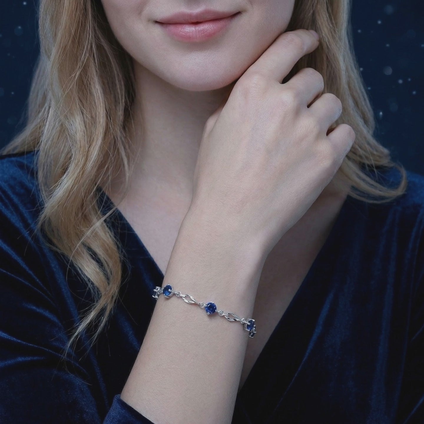 Solid gold station bracelet with simulated sapphires.