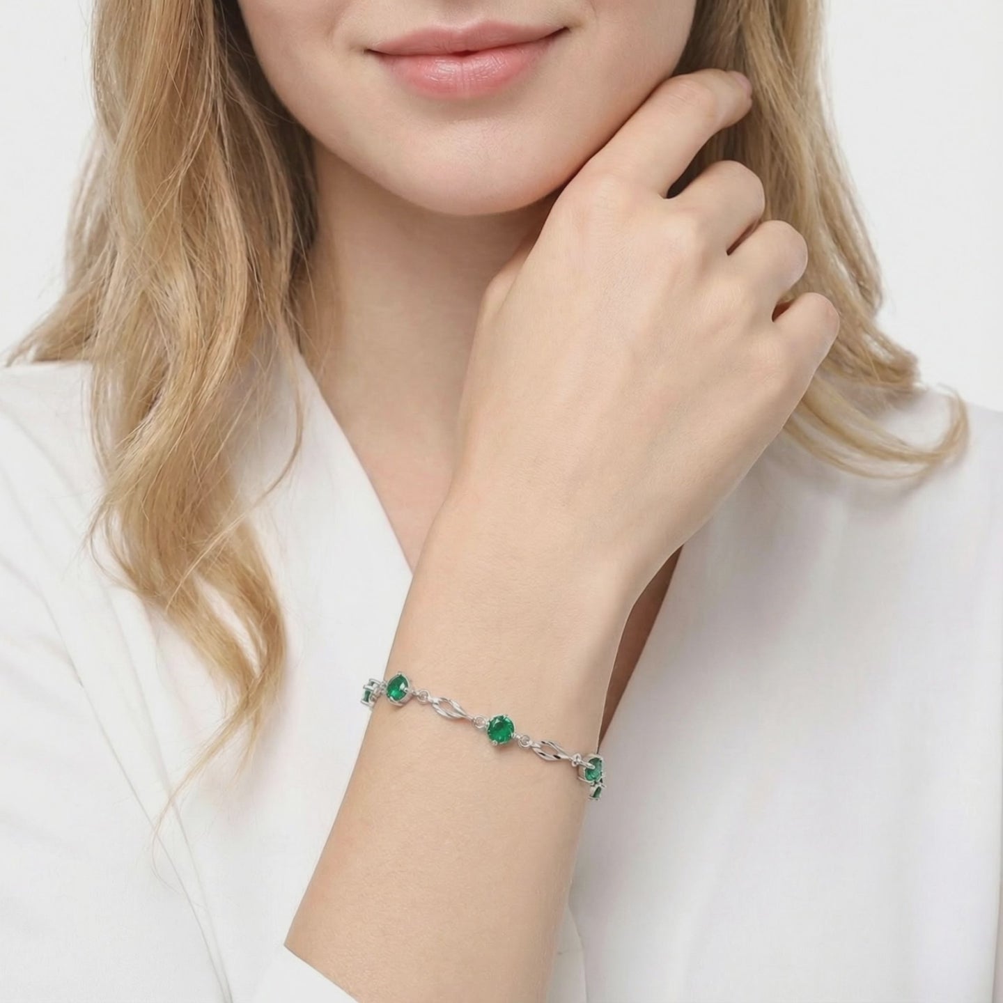 Solid gold bracelet with simulated emeralds.