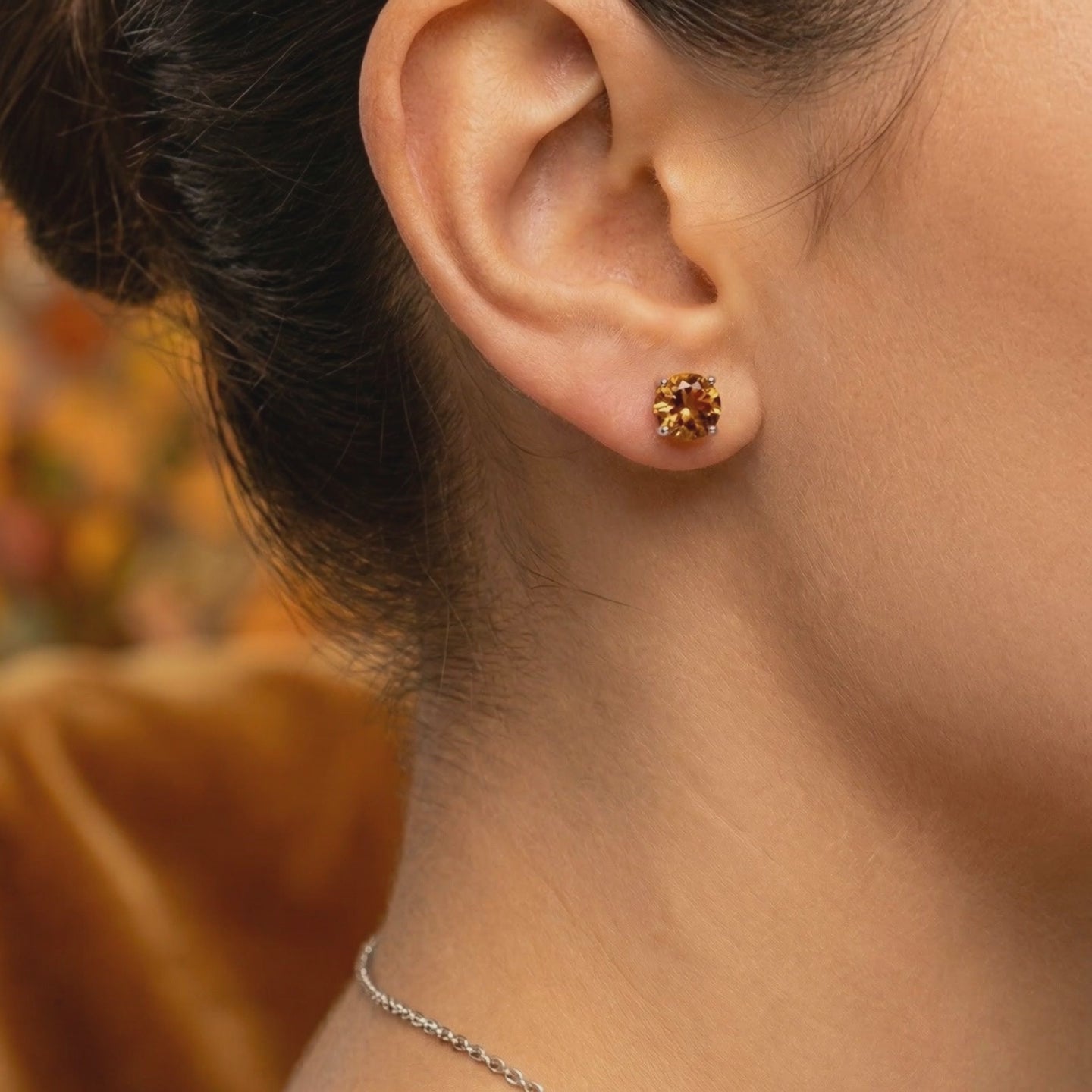 A pair of solid gold stud earrings with simulated topaz.