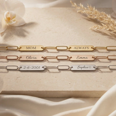 Three gold, rose-gold, and silver link bracelets lie flat, engraved MOM, ALWAYS, Olivia, Emma, 2-6-2001, and Sophia.