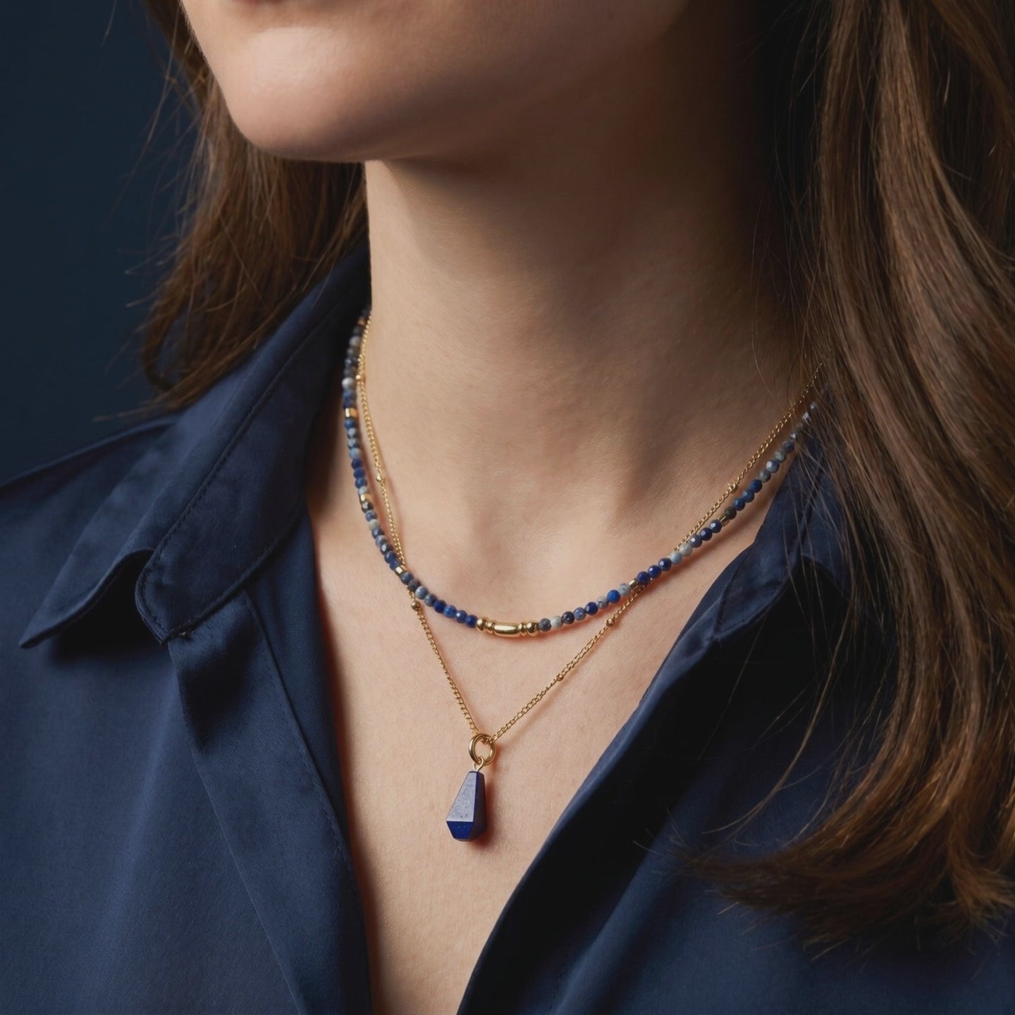 Solid gold necklace with natural lapis lazuli pendant and beads.