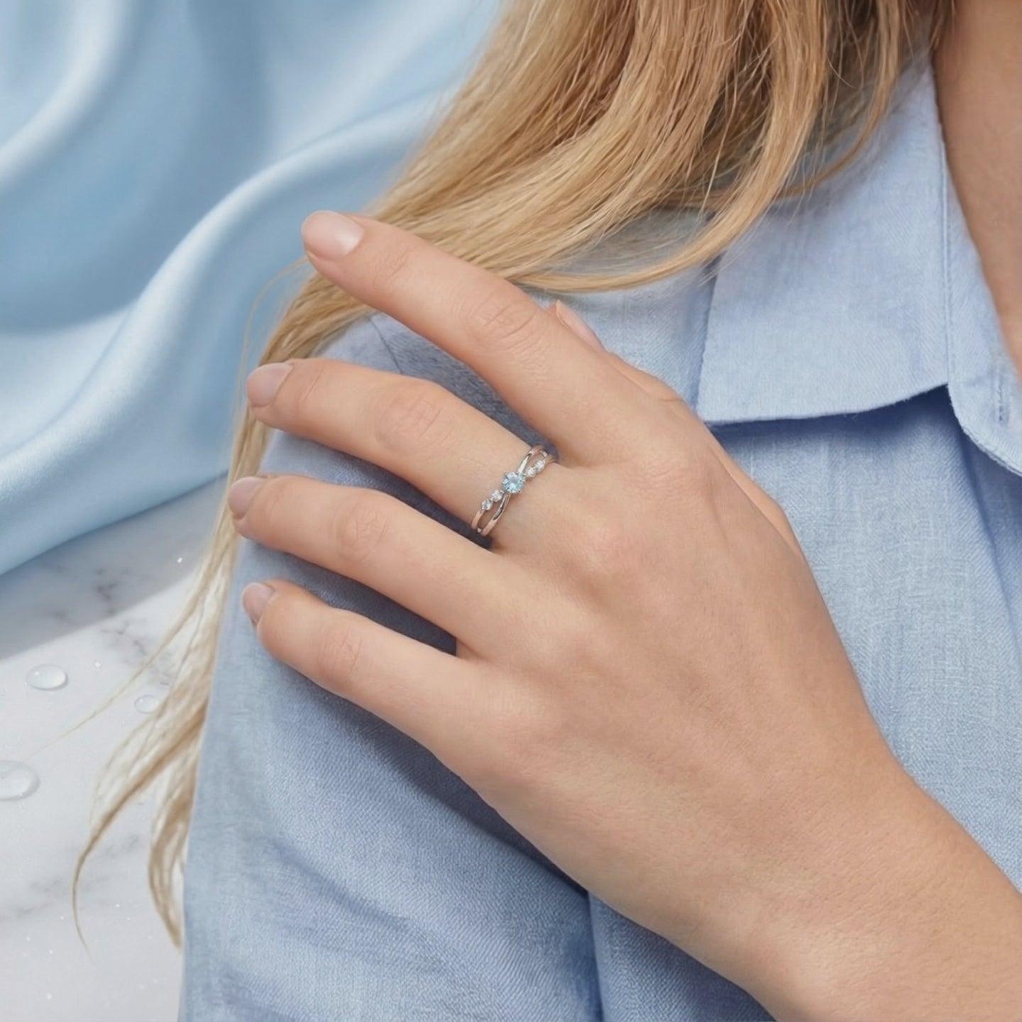 A solid gold ring with a simulated aquamarine.