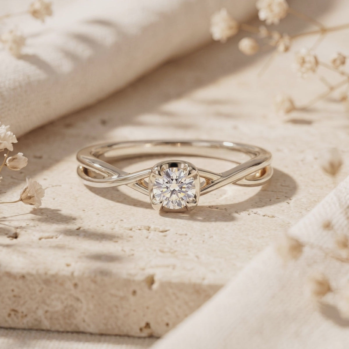 Silver-toned Calydonia ring featuring a round-cut stone and twisted band displayed on a stone surface.