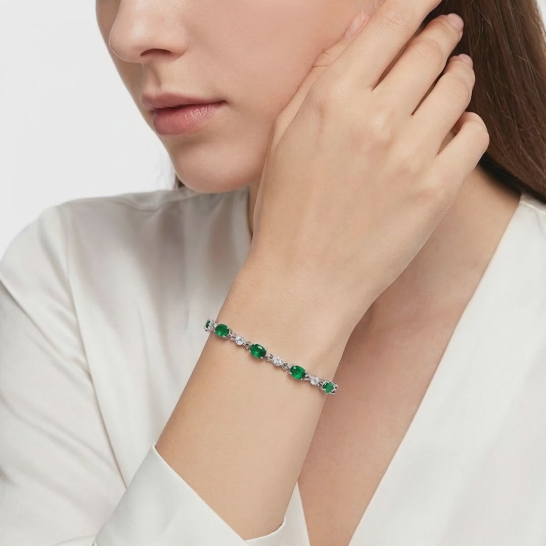 Solid gold bracelet with simulated emeralds.