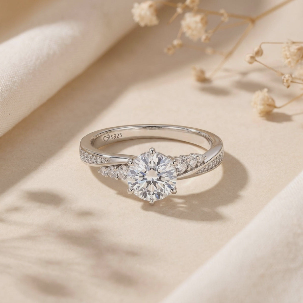 Close-up of the silver moissanite ring with a six-prong round center stone and visible S925 stamp.