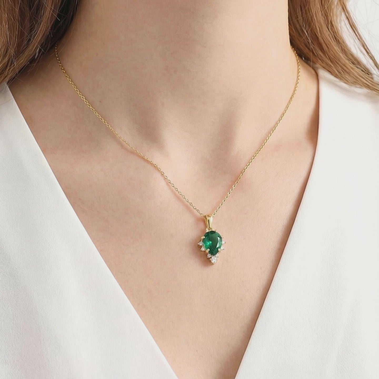 Pear-cut simulated emerald necklace in solid gold.