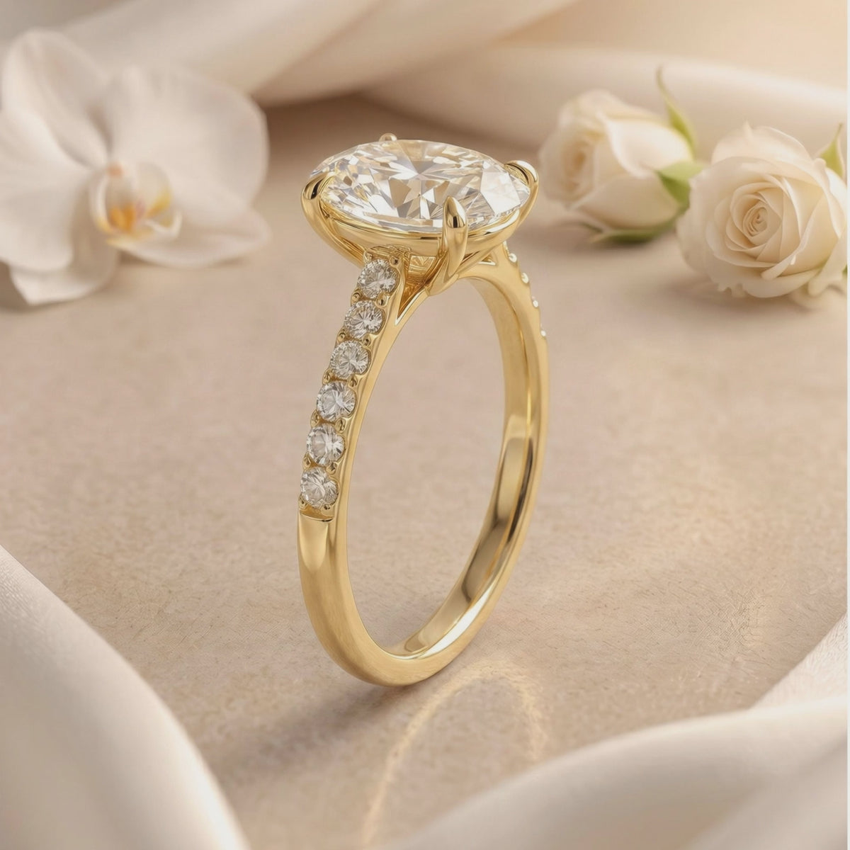 Three-quarter side view of a gold-colored ring with an oval center stone, prong setting, and pavé stones along the shoulders.